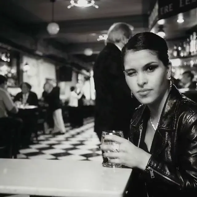 Guest with a glass at the edge of a milonga